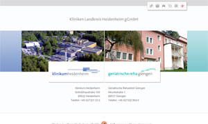 Website-Screenshot mit Luftaufnahme von Klinikgebäuden aus Beton und rosa Fassaden